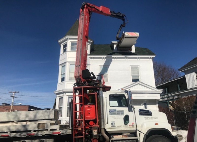 Drywall unloaded by crane in Maine